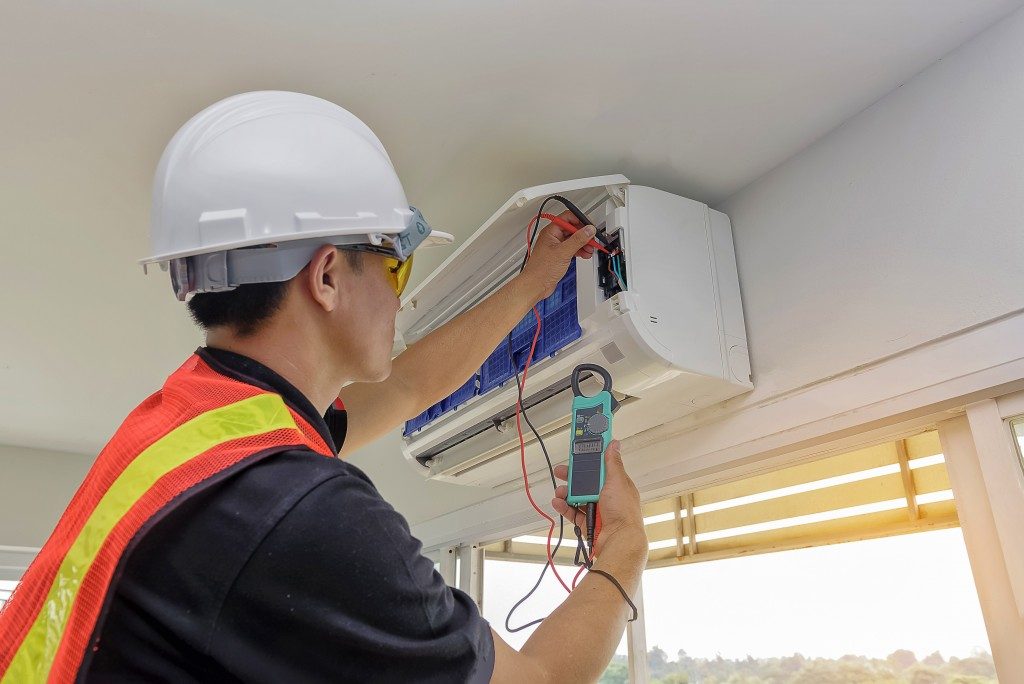 Engineer Repairing Air Conditioner