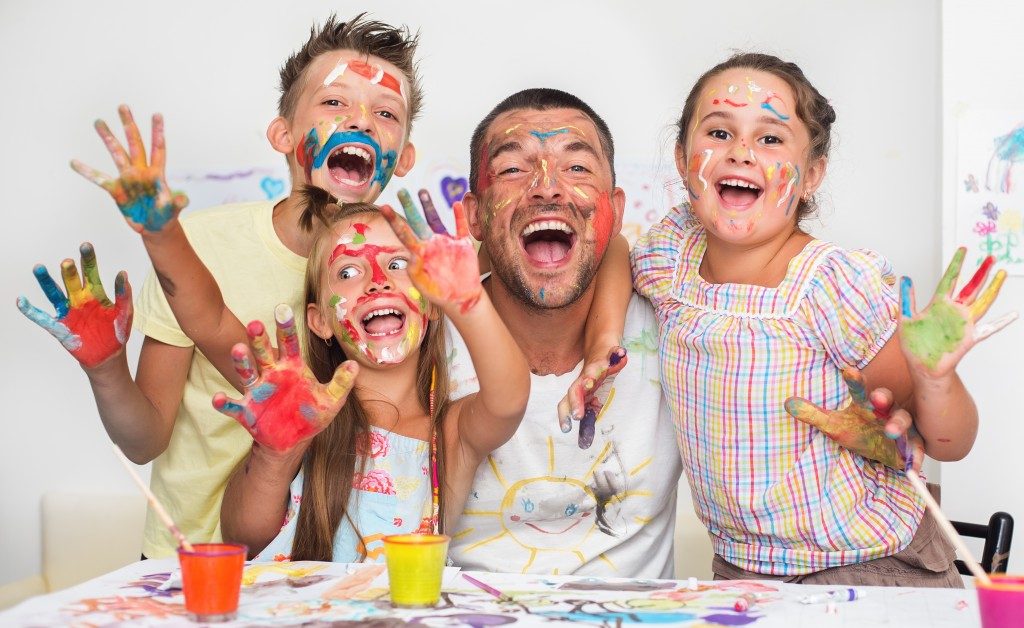 Family covered in paint