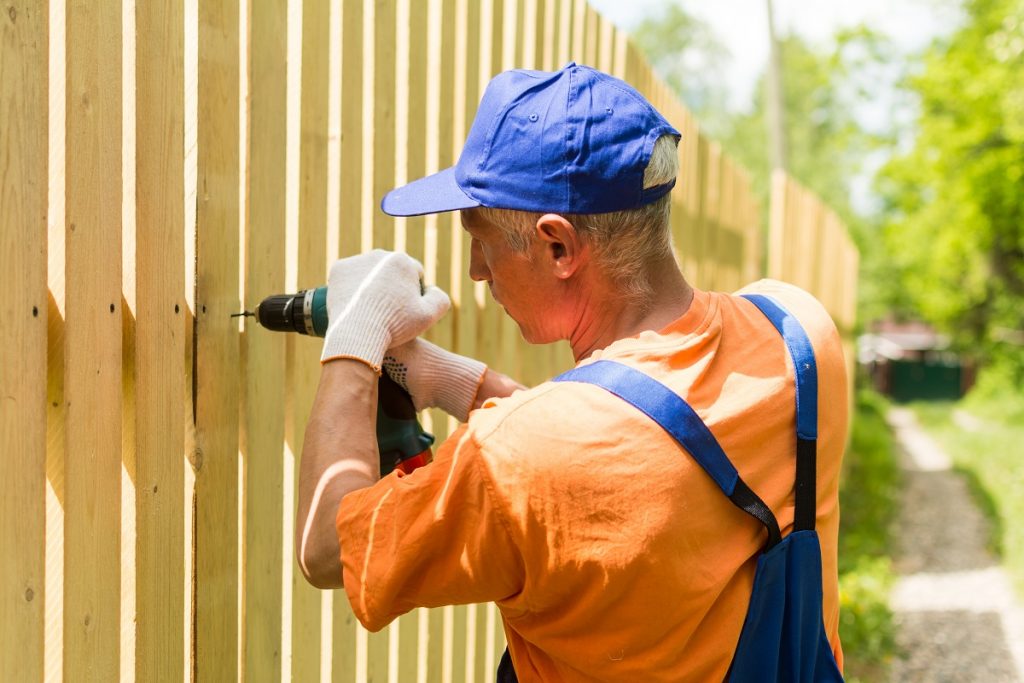 Man installing fence