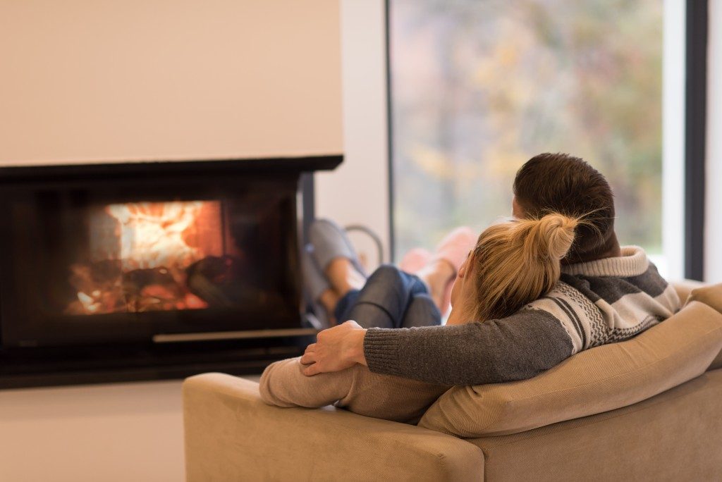 couple in the living room in front of fireplace