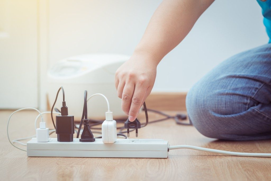 man unplugging plug