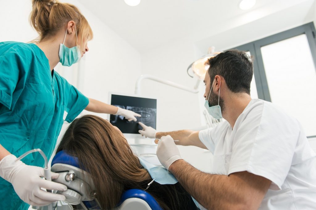 Dentist checking a patient's xray