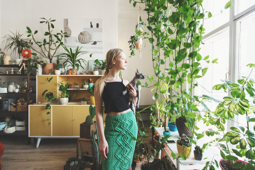 woman surrounded by house plants