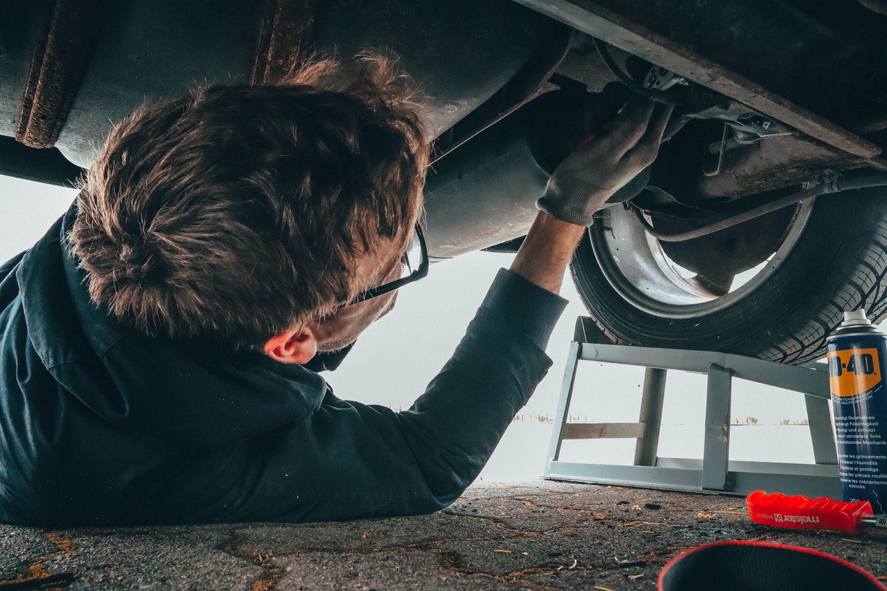 mechanic working on exhaust