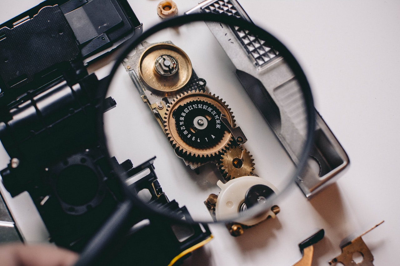 person inspecting some gears