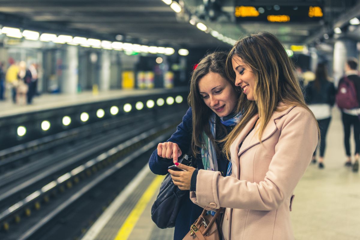 2 women at a train station platform