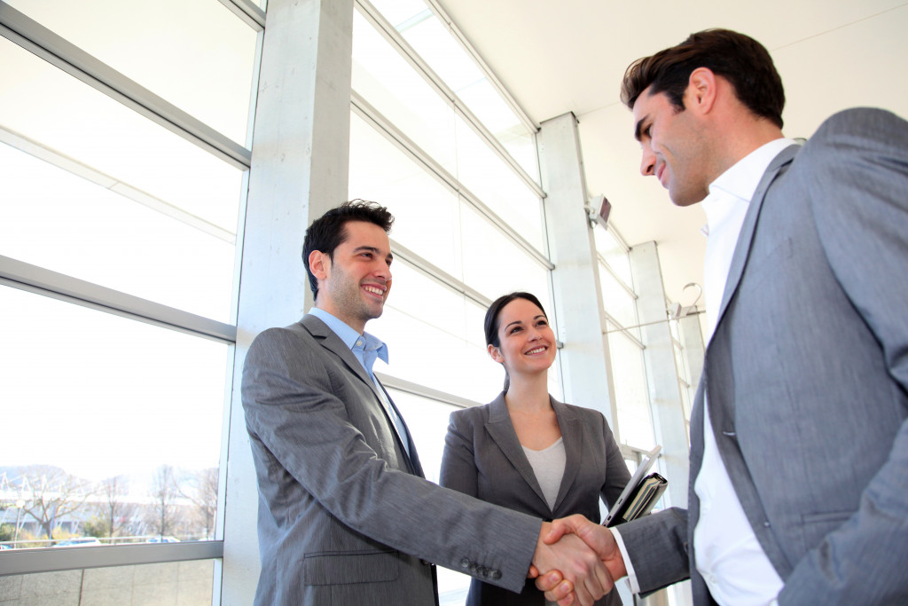 a businessman shaking hands with another businessman