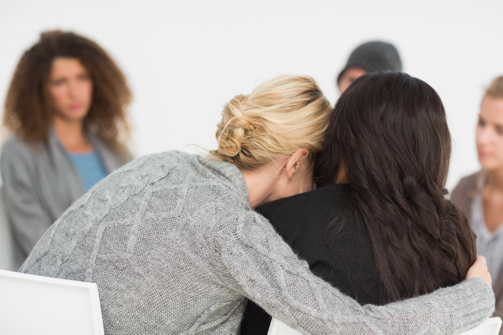 a woman hugging another woman