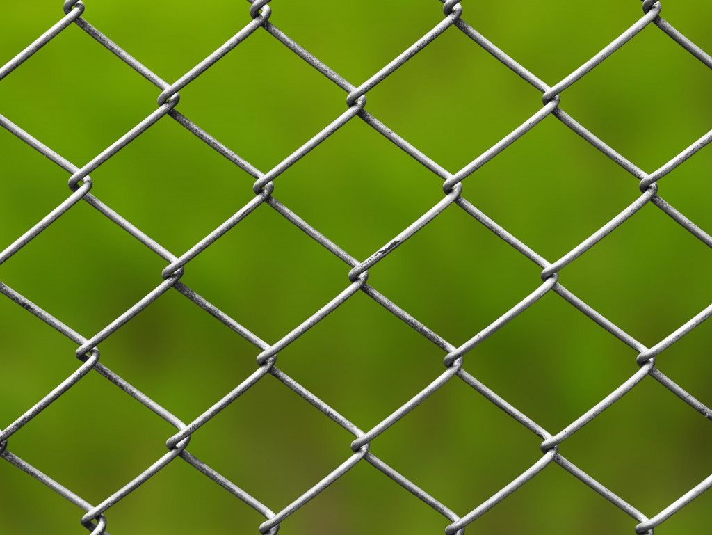 Metal fence with a green background