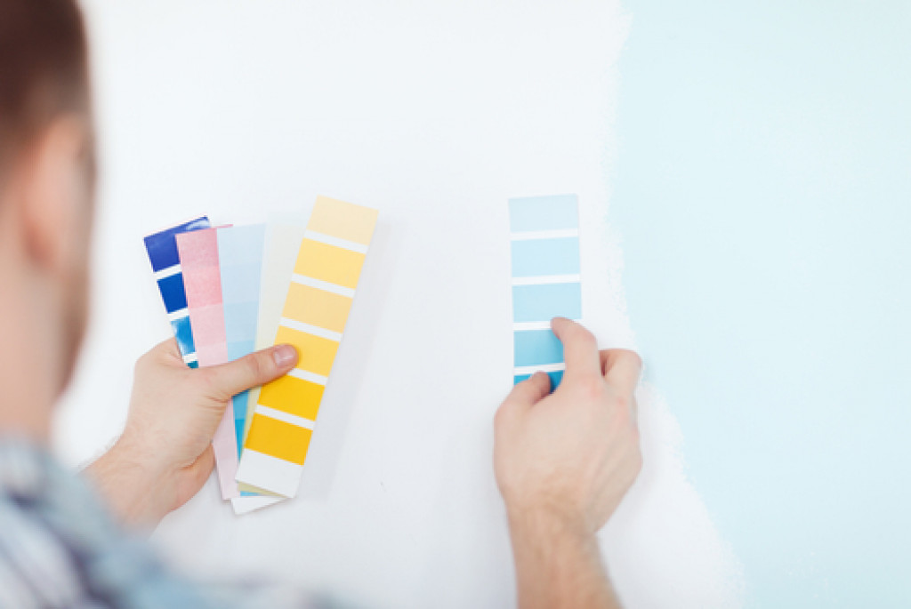 male choosing color palettes for wall blue or yellow paint