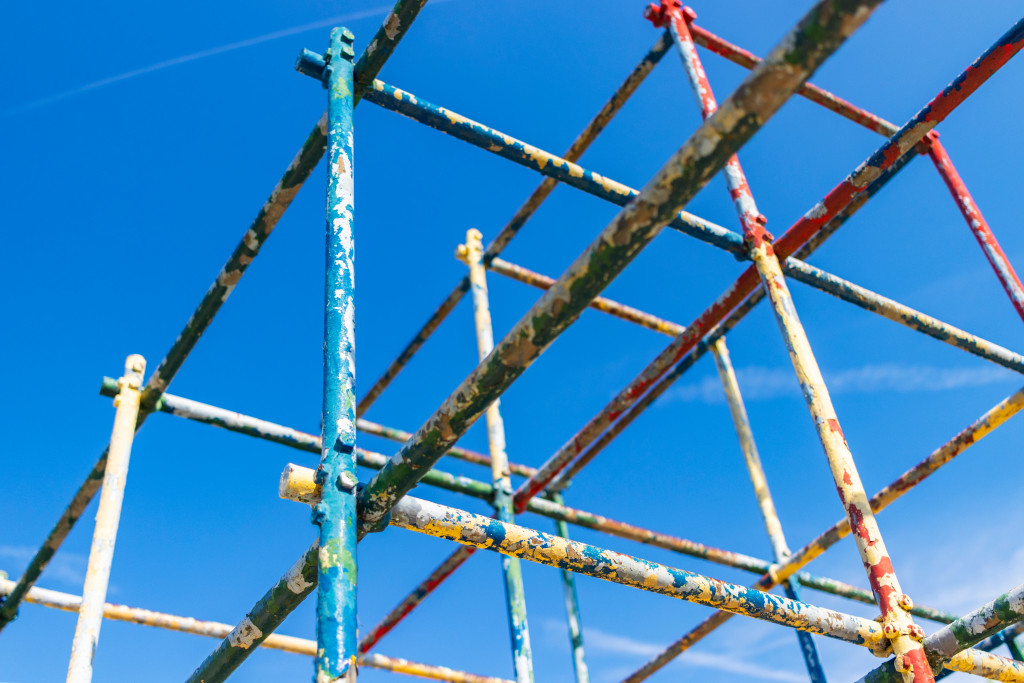 Old Rusty Playground Equipment Jungle Gym with Peeling Paint Against a Blue Sky Selective Focus