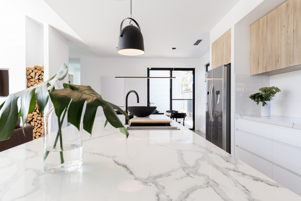 empty kitchen interior with plants and marble countertop