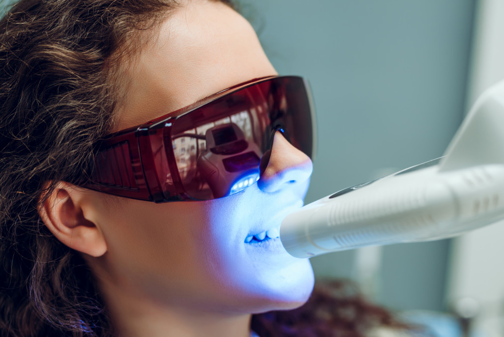 patient at the dental clinic getting a teeth whitening treatment