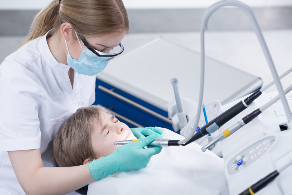 A kid looking terrified while in a dental clinic