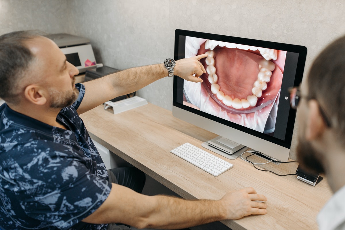 dentist having a client teeth check-up