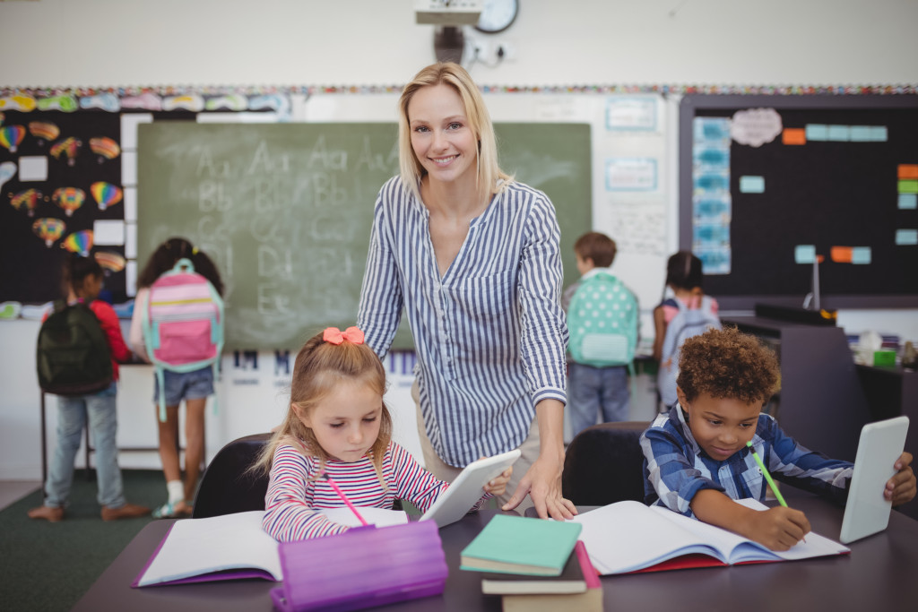 elementary teacher helping her students