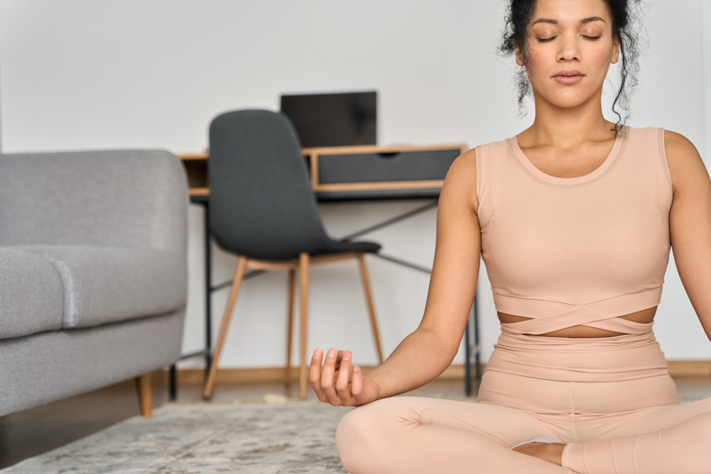 A woman taking a break from work, doing yoga