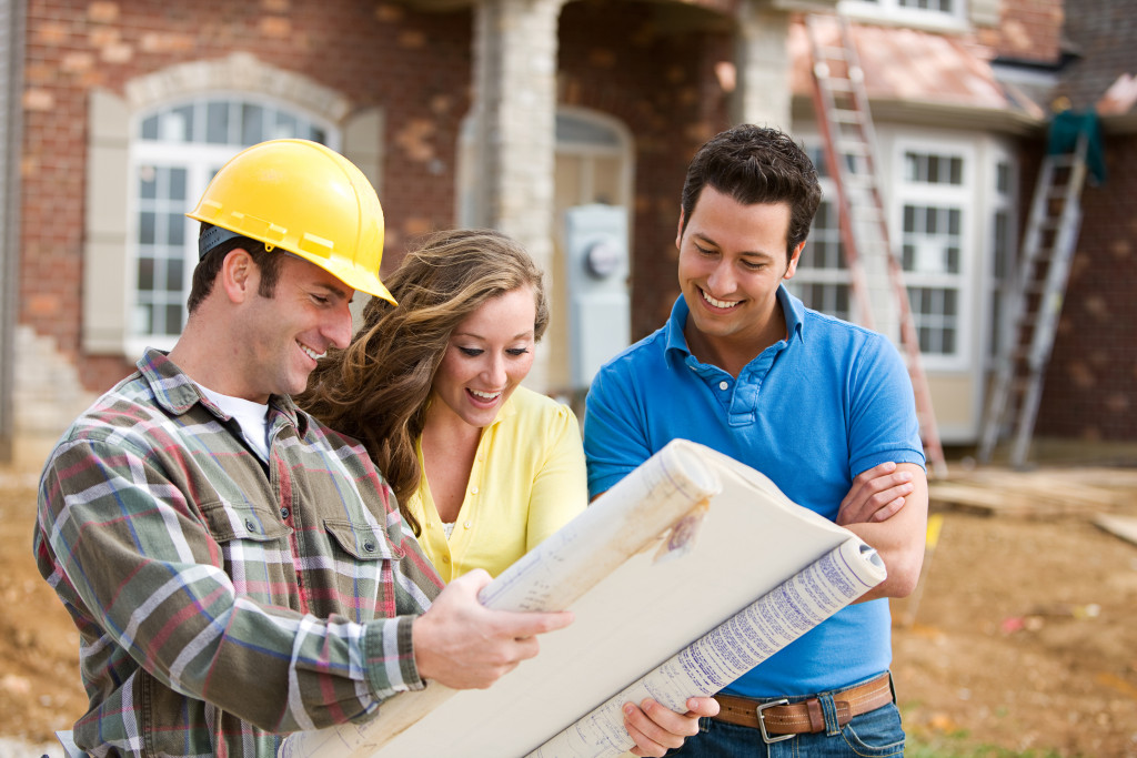 A couple talking to a builder about construction plans