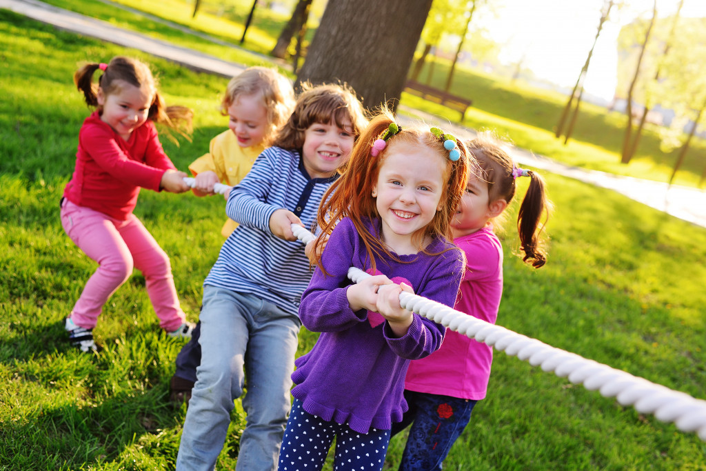 children playing tug of war outdoors