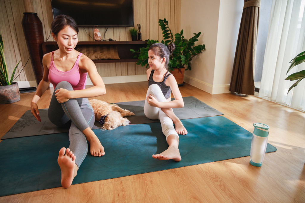 mom and daughter doing yoga at home