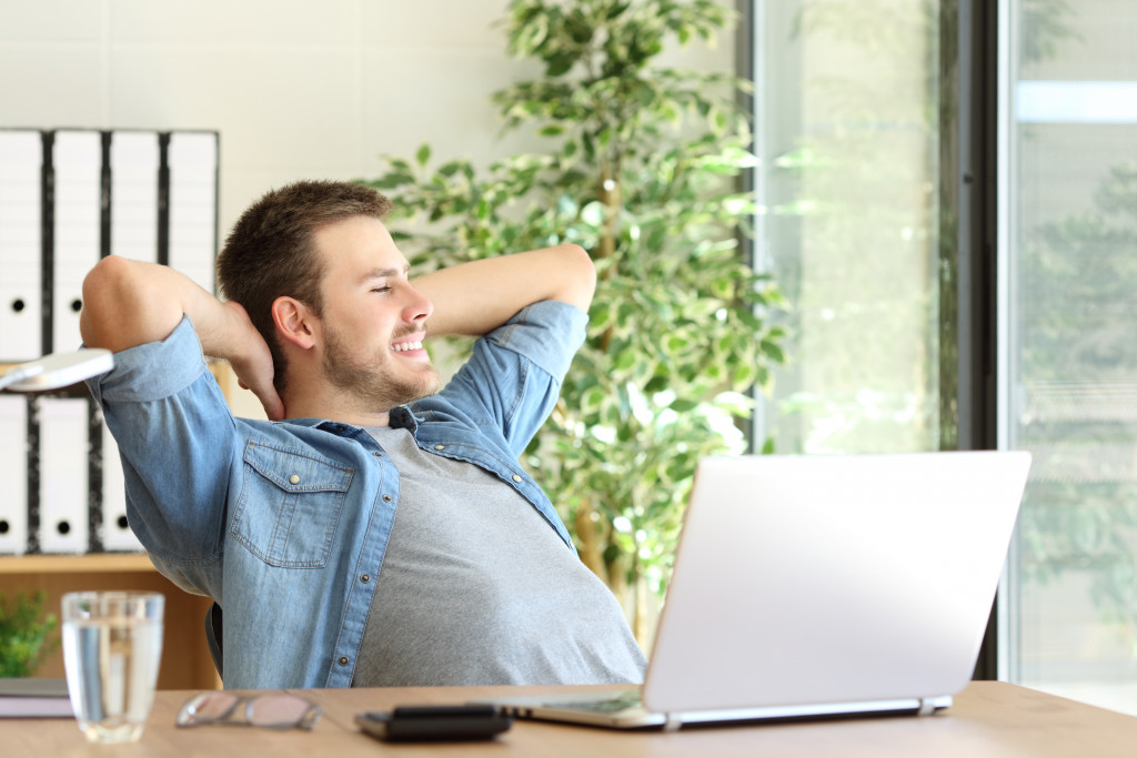 a man in an office desk relaxing