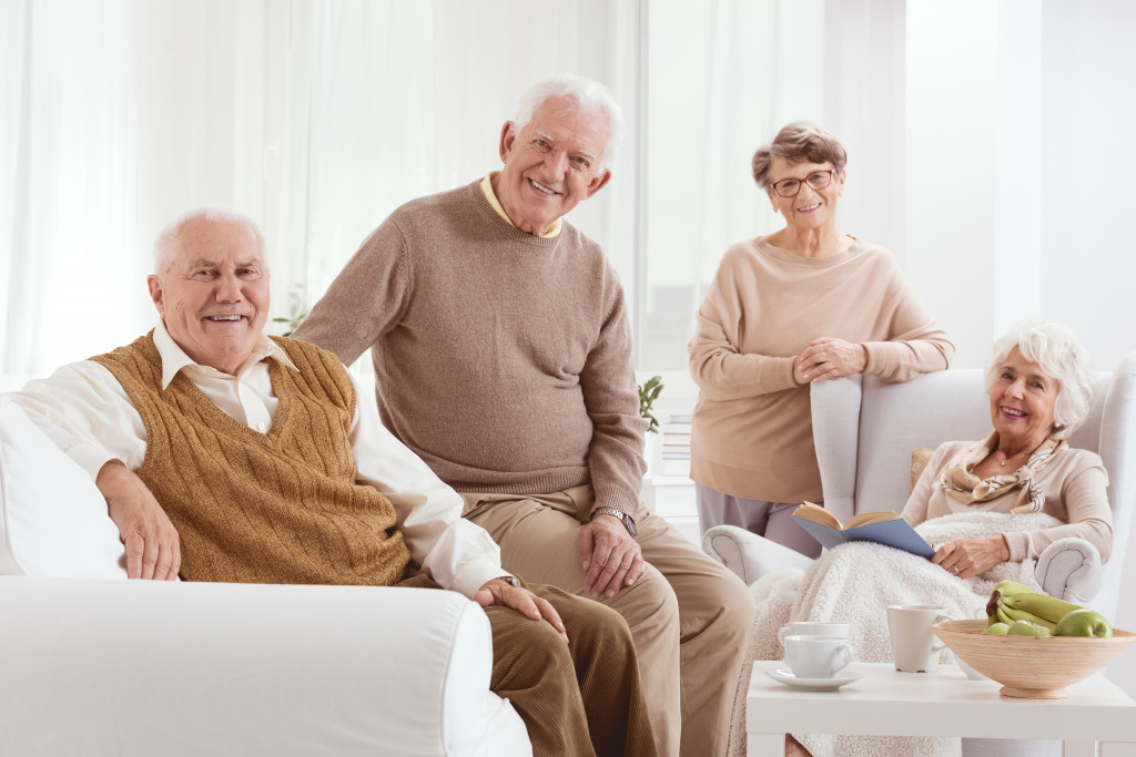 elderly friends talking in a white minimalist living room