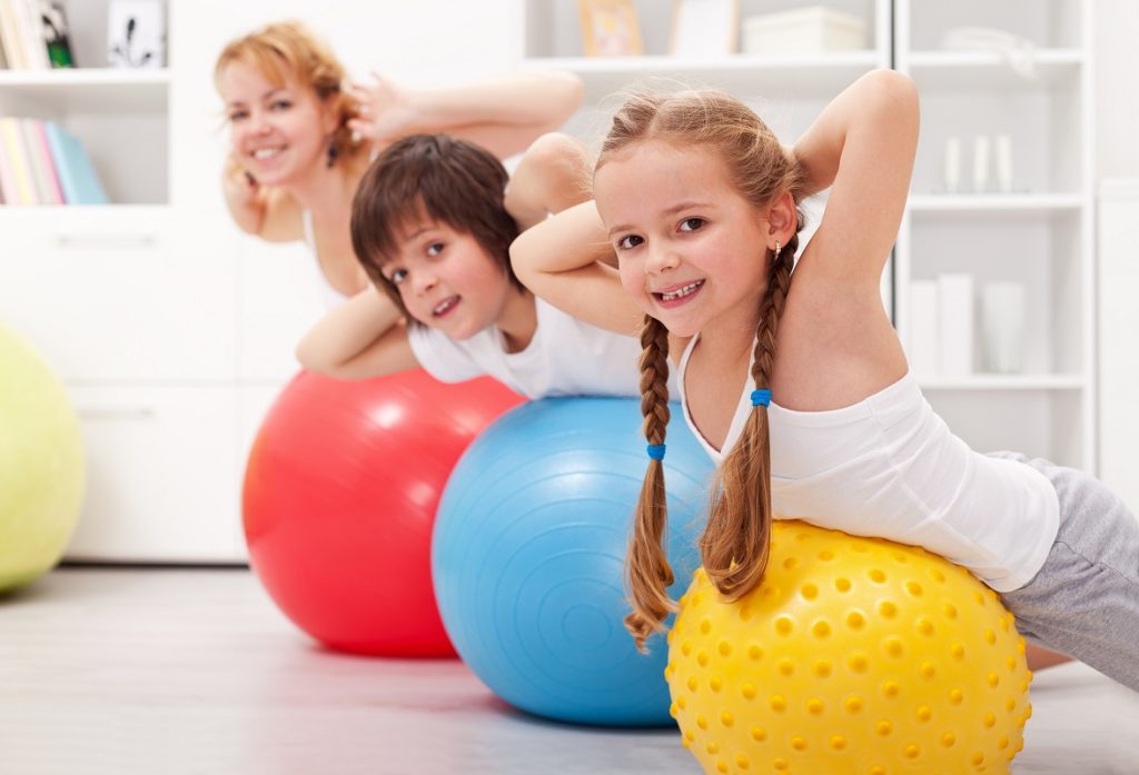 kids exercising with their mom at home