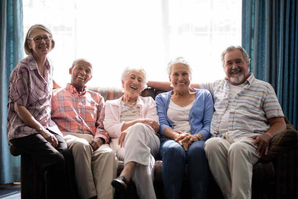 A group of senior citizens smiling to the camera