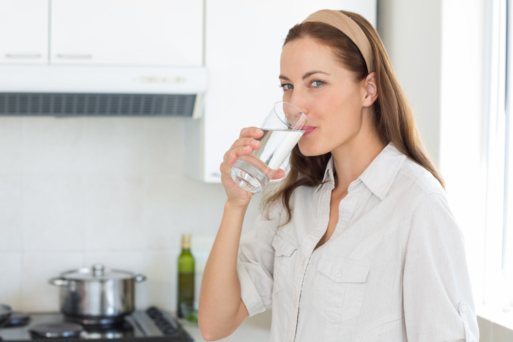 woman in the kitchen drinking water