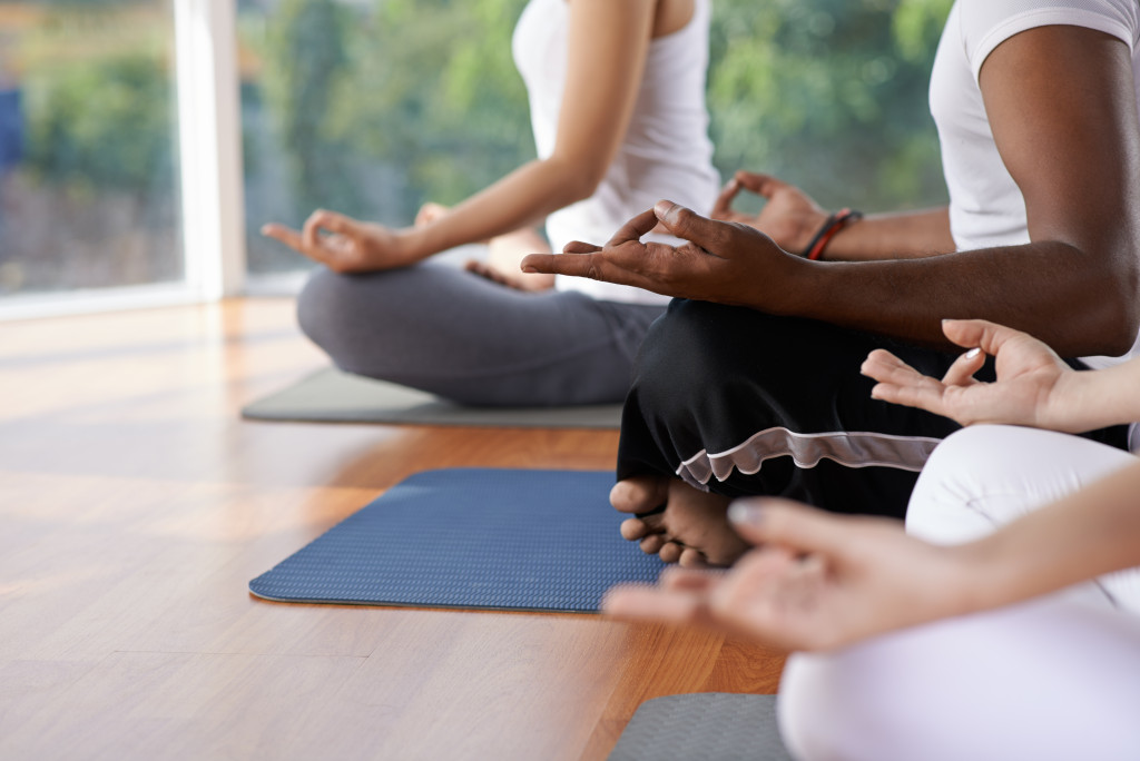 three people doing a meditation