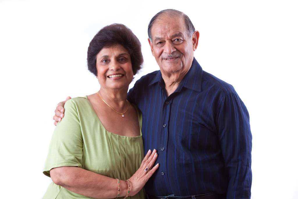 A senior couple smiling to the camera