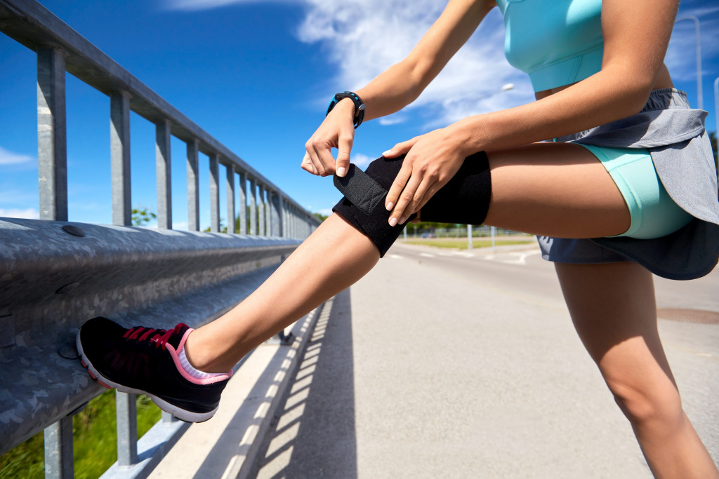 woman with knee brace while running