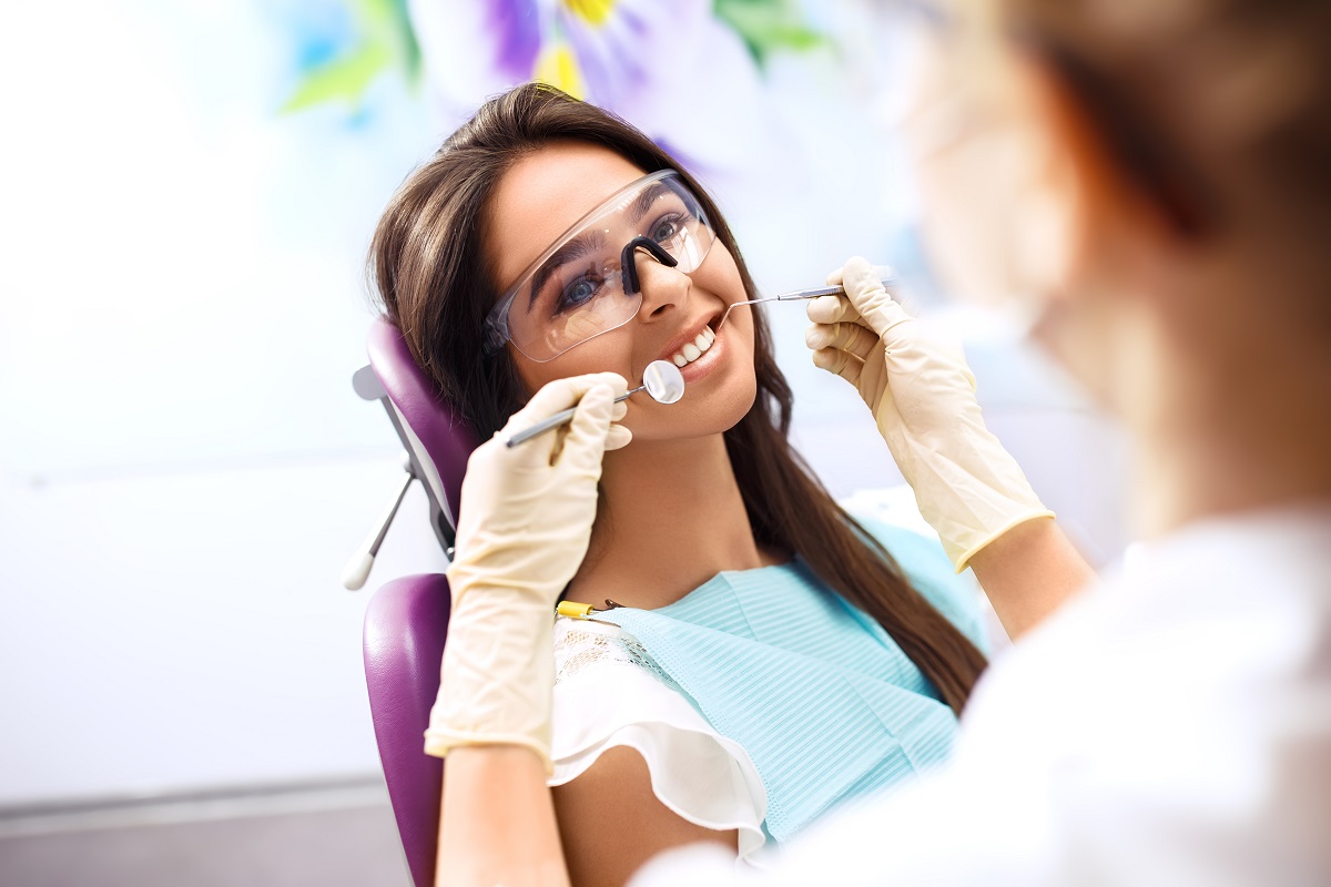 dentist checking patients teeth