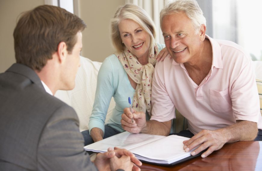 Senior couple working with a financial advisor after retiring.