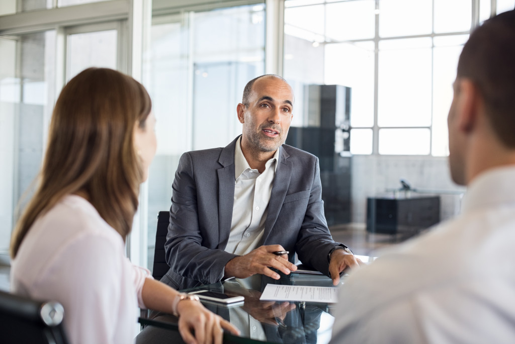 Young couple planning their finances with the help of a financial advisor.