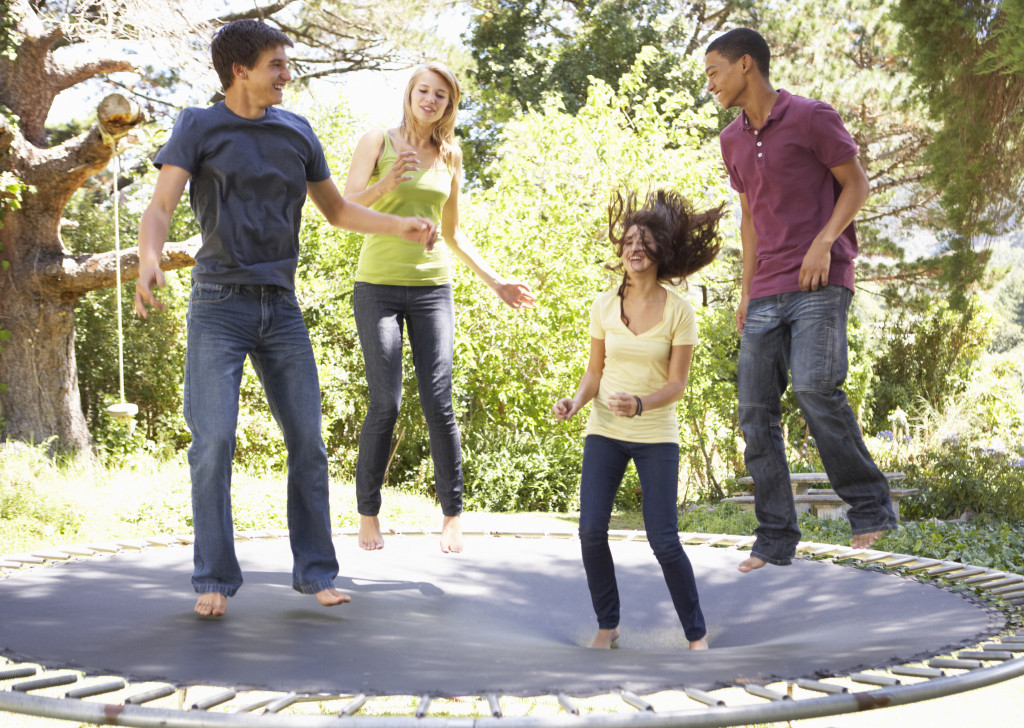 adult people jumping on the trampoline